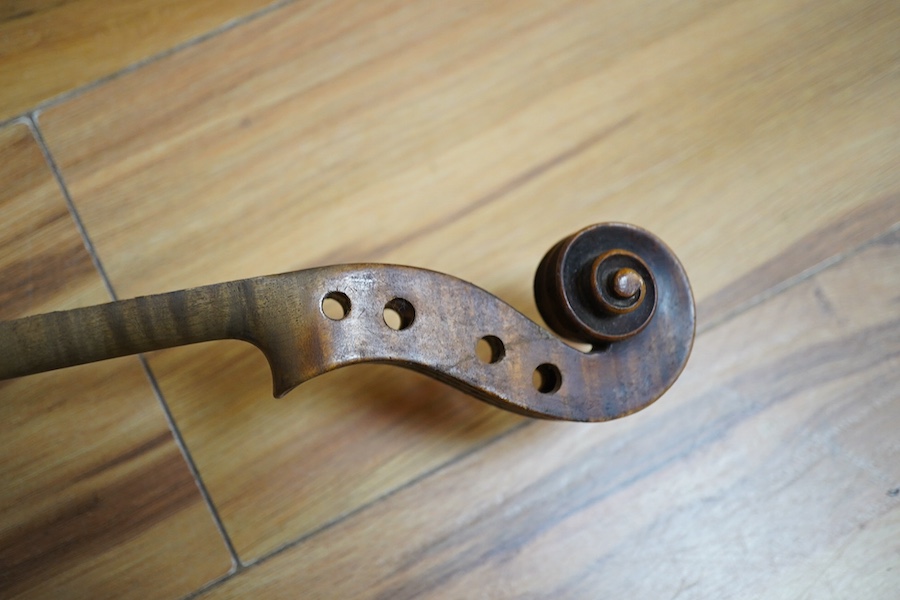 A quantity of violin parts and violins, a ukelele, a double bass scroll, a pinfold metronome, a violin case by Hill, a viola etc. Condition - for restoration